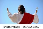 Saint prophet holding cross, praying to God, preaching Christianity back view