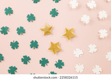 Saint St Patrick's Day. Top view flat lay of paper cut clover leaves festive decor, shamrocks leaf holiday symbol with copy space on colour background, Banner greeting card good lucky concept - Powered by Shutterstock