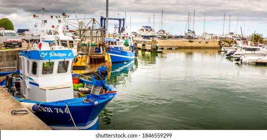 SAINT VAAST, FRANCE - MAY Circa, 2020. Fishing boats in the harbor stopped their work because of the corona covid 19 outbreak. Concept of economic crisis on agriculture business