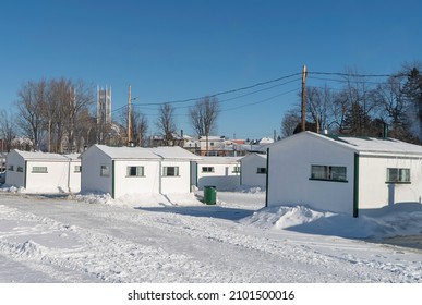 Sainte Anne De La Parade, Quebec  Canada - December 29 2021: A Makeshift Ice Fishing Community Forms On Riviere Sainte-Anne, Complete With Cabins, Rinks, Electricity, Shops, And Play Areas For Kids.