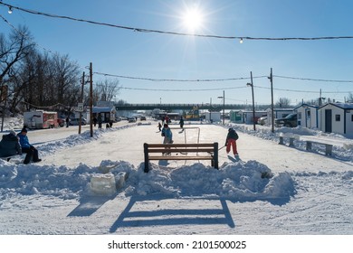 Sainte Anne De La Parade, Quebec  Canada - December 29 2021: A Makeshift Ice Fishing Community Forms On Riviere Sainte-Anne, Complete With Cabins, Rinks, Electricity, Shops, And Play Areas For Kids.