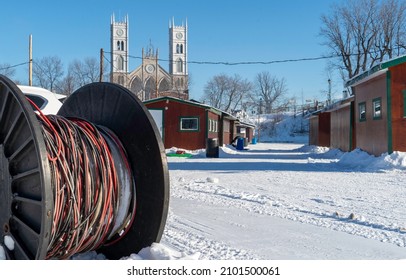 Sainte Anne De La Parade, Quebec  Canada - December 29 2021: A Makeshift Ice Fishing Community Forms On Riviere Sainte-Anne, Complete With Cabins, Rinks, Electricity, Shops, And Play Areas For Kids.