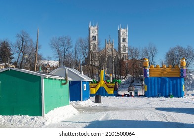 Sainte Anne De La Parade, Quebec  Canada - December 29 2021: A Makeshift Ice Fishing Community Forms On Riviere Sainte-Anne, Complete With Cabins, Rinks, Electricity, Shops, And Play Areas For Kids.