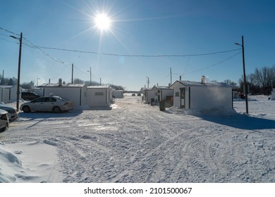 Sainte Anne De La Parade, Quebec  Canada - December 29 2021: A Makeshift Ice Fishing Community Forms On Riviere Sainte-Anne, Complete With Cabins, Rinks, Electricity, Shops, And Play Areas For Kids.