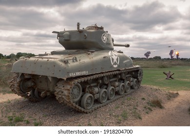 Sainte-Marie-du-Mont, France; 22 08 2018: M4 Sherman Tank Of The Allied Troops Targeting Two German WWII Bombers In The Normandy Coast On A Cloudy Day