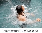 Saint-Gervais Mont-Blanc thermal spa. Balneotherapy. Woman enjoying of water jet.  France. 