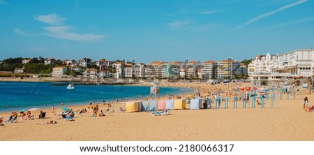 Saint-Jean-de-Luz, France - June 24, 2022: Panoramic view of La Grande Plage beach in Saint-Jean-de-Luz, France, with many people enjoying the good weather in a summer day