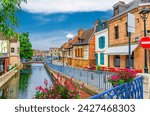 Saint-Leu quarter with traditional fachwerk houses and brick buildings on embankment of Somme river water canal with bridges in Amiens historical city centre, Hauts-de-France Region, Northern France