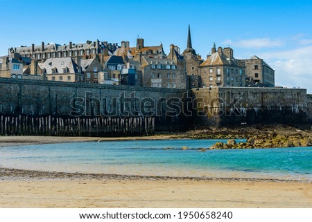 Saint-Malo, Brittany, France: View of the historic fortified part of town (Intra-Muros) from the Sillon beach on a sunny morning at low tide. 