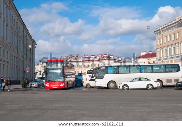 SAINT-PETERSBURG, RUSSIA, APRIL 15, 2017:\
Excursion buses and Hop On Hop Off City Tour Bus near The Palace\
Square and The State Hermitage Building in sunny April\
day