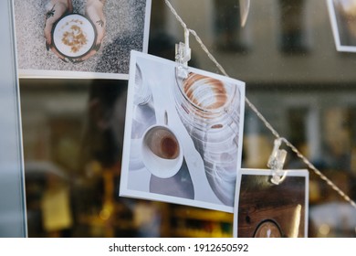 Saint-Petersburg, Russia - Autumn 2020. Some Polaroid Photos Hanging On A Wire In A Window Of Coffeeshop .