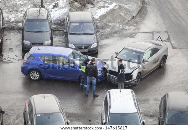 SAINT-PETERSBURG, RUSSIA - CIRCA MARCH, 2013:\
Drivers during cars accident and police officer talk about\
registration and paperwork on circa March, 2013 in\
Saint-Petersburg, Russia. No one was\
injured