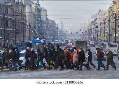 SAINT-PETERSBURG, RUSSIA - DECEMBER 05 2021: Downtown street cityscape. Pedestrian crowds crossing the Nevsky prospect, cars, city transport. 