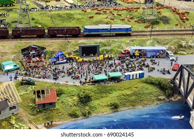 Saint-Petersburg, Russia - January 03th 2015: Museum Grand Maket Rossiya - The Breadboard Model Of The Railway. Model Of The Train. Little Toy Bikers Listen To The Concert.