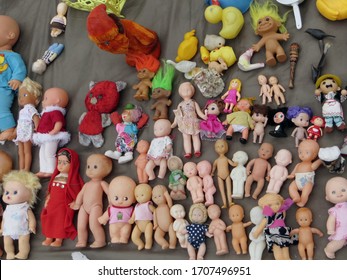 Saint-Petersburg / Russia - January 31 2015: many old vintage toys and dolls at a flea market sale in the city. Plastic objects from Soviet Union and beyond, baby dolls, troll, stuffed animals.