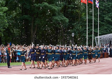 SAINT-PETERSBURG, RUSSIA - JUNE 21 2019: Female Students Of A Military Academy Graduation Ceremony Marching On The Parade Ground And Throwing Flower Petals