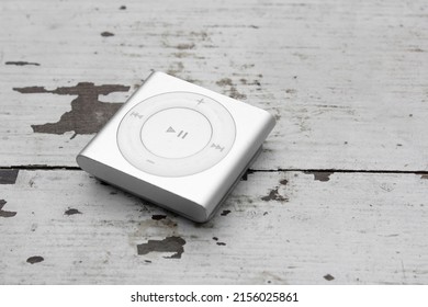 Saint-Petersburg, Russia - May 10, 2022: Old silver music player. iPod Shuffle lies on a wooden surface
