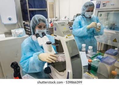 Saint-Petersburg, Russia - November 16, 2016: Scientist biologist conducting research Medications in an isolated lab behind glass