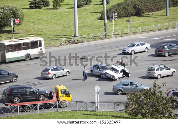 SAINT-PETERSBURG, RUSSIA-AUGUST 16, 2013: Car\
accident in street intersection on August 16, 2013 in\
Saint-Petersburg, Russia. Crash between two cars on drive at red\
traffic light. No one was\
injured