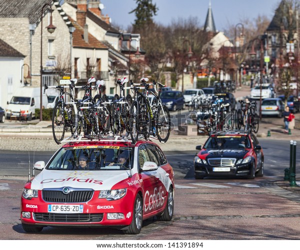 SAINT-PIERRE-LES-NEMOURS,FRANCE,MARCH\
4:Row of technical teams cars following the cyclists during the\
first stage of the bicycle road race Paris Nice on March 4 2013 in \
Saint-Pierre-les-Nemours