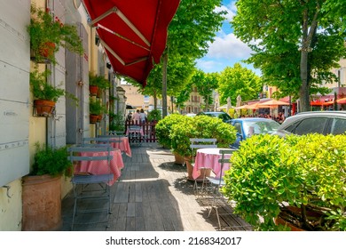 Saint-Remy-de-Provence, France - June 2 2022: An Empty Sidewalk Cafe In The Historic Town Of Saint Remy In The Provence Cote D'Azur Region Of Southern France.