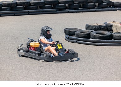 Saint-Zotique, Canada - June 25, 2022: A Young Child Accelerates Around A Corner Of An An Outdoor Go Kart Track