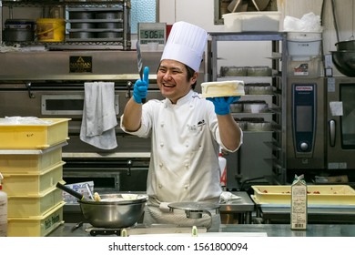 Sakaiminato, Japan - September 27th, 2019: A Japanese Male Pastry Chef Smiling Holding A Round Cake To Decorate At His Store's Kitchen.