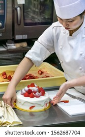 Sakaiminato, Japan - September 27th, 2019: A Japanese Female Pastry Chef Showing A Cake Decorated With Cream And Strawberries.