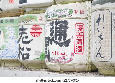 Sake Casks - Barrels of Japanese rice wine lined and stacked at the entrance of a Shrine.