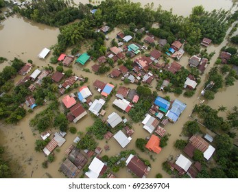 Sakonnakhon, Thailand - August 3, 2017 (Ban kang tha lap village,Kusumal district,Sakonnakhon) : Flood waters overtake a house and rice field in northeast of Thailand from above view by drone