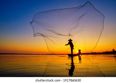 SAKONNAKHON, THAILAND – FEBRUARY 5: Asian man sowing fishing nets in the water, in the morning of the rising sun on February 5, 2017 in Sakonnakhon, Thailand.