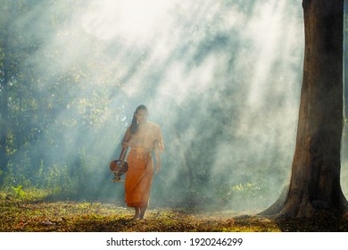 SAKONNAKHON, THAILAND – FEBRUARY 5: A Monk Was Walking Away From The Smoke Of A Big Tree On February 5, 2017 In Sakonnakhon, Thailand.