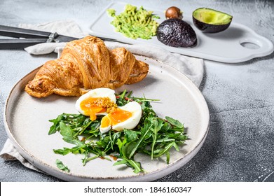 Salad With Avacado, Arugula, Croissant And Egg. Gray Background. Top View