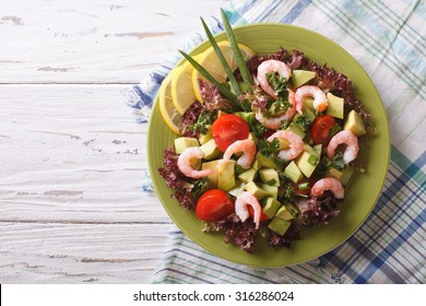 Salad With Avocado, Shrimp And Vegetables On A Plate. Horizontal View From Above
