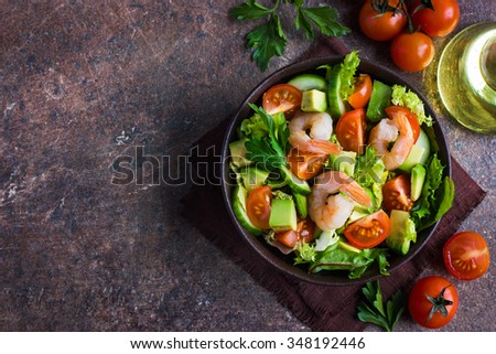 salad with avocado and shrimps in bowl, top view, copy space