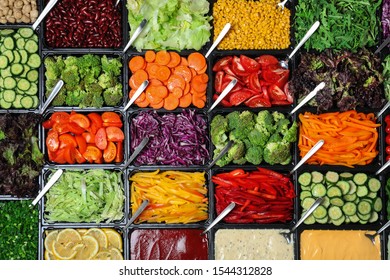 Salad Bar With Different Fresh Ingredients As Background, Top View