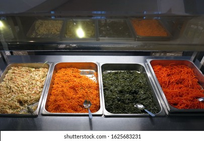 A Salad Bar With A Vitamin Range On The Food Distribution Line Is Reflected In The Glass.