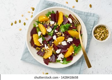 salad with beet, curd, avocado, orange, feta, ricotta and pumpkin seeds, keto ketogenic dash diet, modern and pastel background, top view - Shutterstock ID 1428418658
