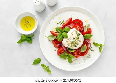 Salad Caprese with tomato, mozzarella and basil, top view - Shutterstock ID 2148990641