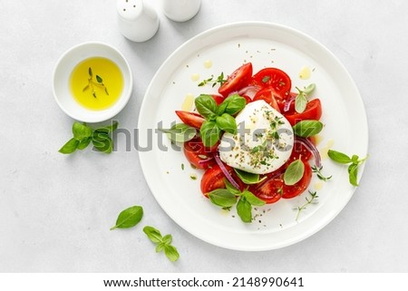Salad Caprese with tomato, mozzarella and basil, top view