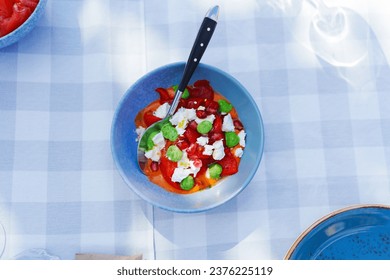 Salad with cheese of vegetables, Brussels sprouts and pomegranate berries in a blue plate on a checkered tablecloth. - Powered by Shutterstock