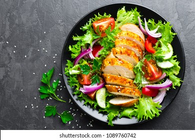 Salad with chicken meat. Fresh vegetable salad with chicken breast. Meat salad with chicken fillet and fresh vegetables on plate - Powered by Shutterstock