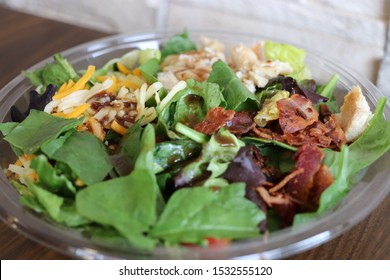 Salad In A Clear Round Plastic Bowl.