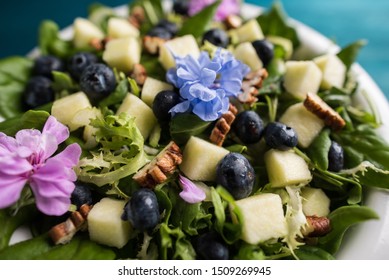 Salad with comestible flowers and grapes. - Shutterstock ID 1509269945