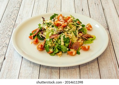 salad cone with bacon, lamb's lettuce, chopped cherry tomatoes, iceberg lettuce and mayonnaise sauce - Powered by Shutterstock