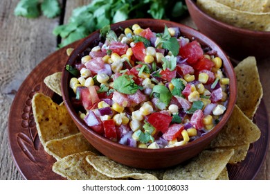 Salad With Corn, Tomatoes And Cilantro In Latin American. Served With Corn Chips