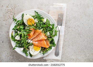 Salad with dandelion leaves, smoked salmon, egg and fresh cheese - Powered by Shutterstock