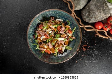 Salad With Duck Walnuts, Prunes And Brie Cheese. Cold Veggie Appetizer With Arugula, Cherry Tomatoes, Poultry Fillets, Prunes, Cheese And Sun-dried Tomatoes.