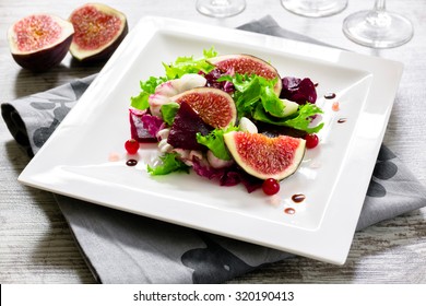 Salad With Fig, Beet, Cranberry And Mozzarella On A Square Plate