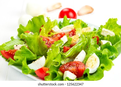 salad with fresh tomatoes, mozzarella cheese and quail eggs